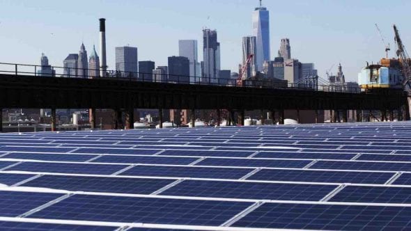 A BROOKLYN NAVY YARD ROOFTOP COVERED WITH SOLAR PANELS, FEBRUARY 14. STATE OFFICIALS SAID INVESTMENTS IN RENEWABLE PROJECTS LIKE THIS ONE WILL HELP REPLACE THE POWER LOST WITH CLOSURE OF INDIAN POINT NUCLEAR PLANT. CREDIT: AP/MARK LENNIHAN