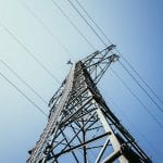 Close up of electrical tower and blue sky Renewable energy and smart grid - optimised