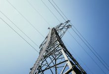 Close up of electrical tower and blue sky Renewable energy and smart grid - optimised