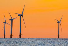 regulatory Offshore wind farm energy turbines at dawn