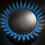 hydrogen Gas Burner with Blue Flames on a dark Kitchen Stove - optimise