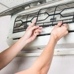 Young man Cleaning and washing maintenance dirty filter - optimised air conditioners