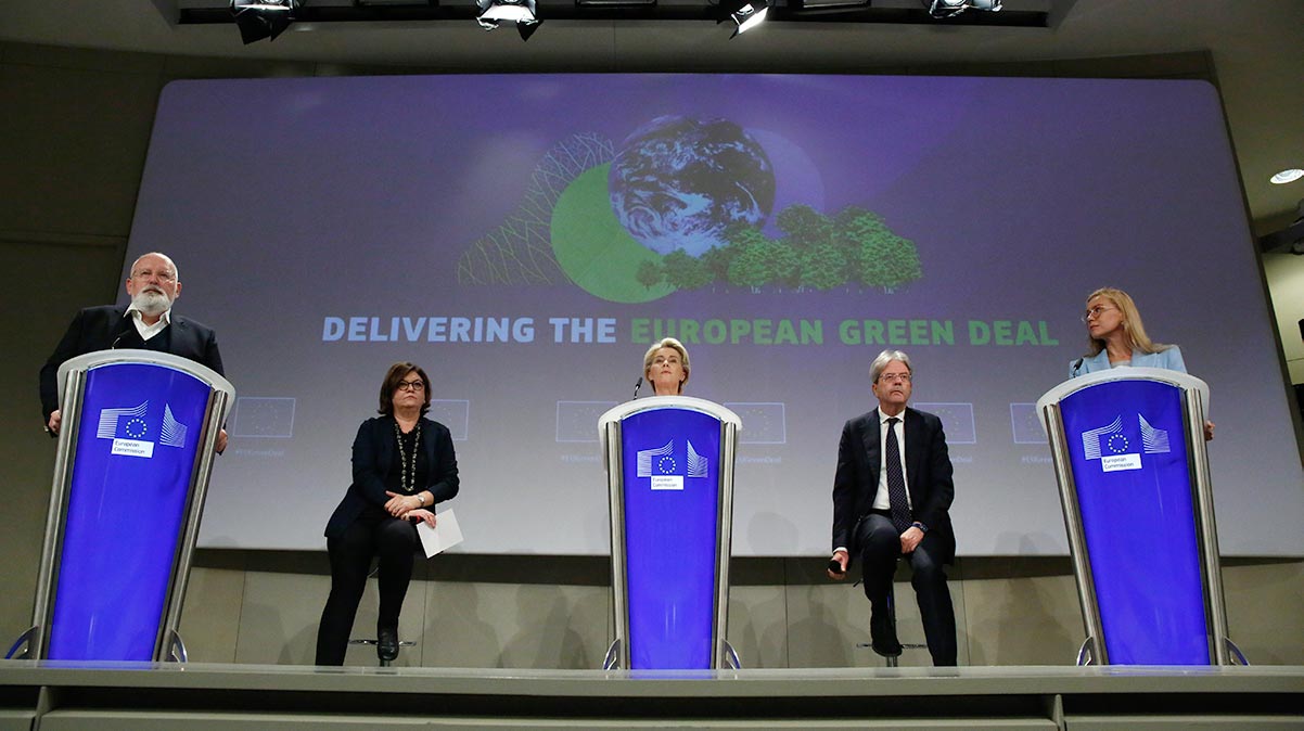 European Commission President Ursula von der Leyen, center, and European Commissioner for European Green Deal Frans Timmermans, left, speak during a media conference at EU headquarters in Brussels. (AP Photo/Valeria Mongelli)