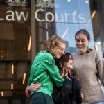 High School students Ava Princi, Izzy Raj-Seppings and Laura Kirwin embrace outside The Federal Court of Australia in Sydney. (AAP Image/James Gourley)
