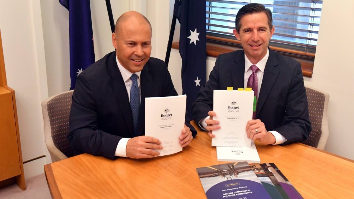 Treasurer Josh Frydenberg and Minister for Finance Simon Birmingham pose for the media with the 2022/23 federal budget at Parliament House in Canberra, Tuesday, March 29, 2022. Treasurer Fydenberg will today hand down the 2022/23 federal budget. (AAP Image/Mick Tsikas)