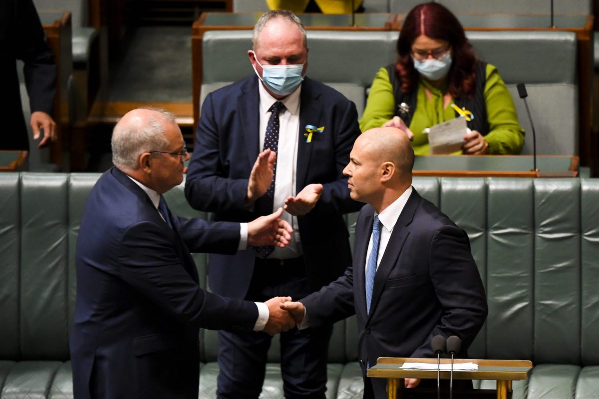 Australian Treasurer Josh Frydenberg is congratulated by Australian Prime Minister Scott Morrison after handing down his fourth budget in the House of Representatives at Parliament House in Canberra. (AAP Image/Lukas Coch)