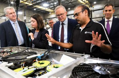 Opposition Leader Anthony Albanese speaks to a worker as he visits the Tritium EV battery charger manufacturing line. (AAP Image/Lukas Coch)