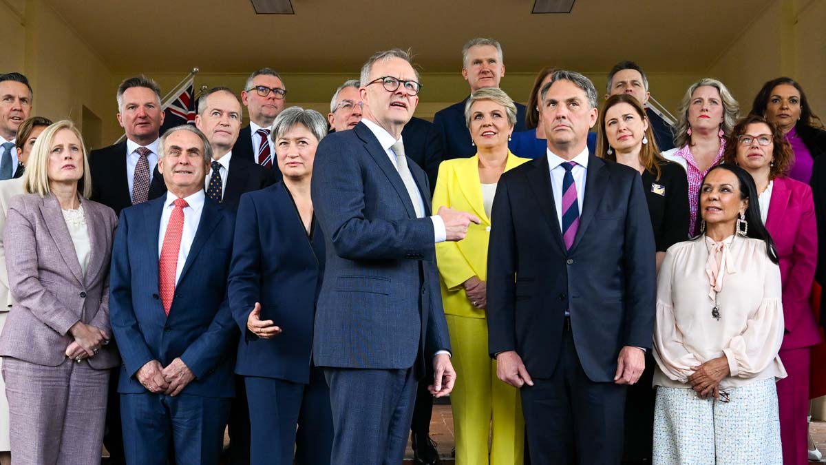 Prime Minister Anthony Albanese poses for photographs with his newly sworn-in cabinet after a swearing-in ceremony at Government House. (AAP Image/Lukas Coch)