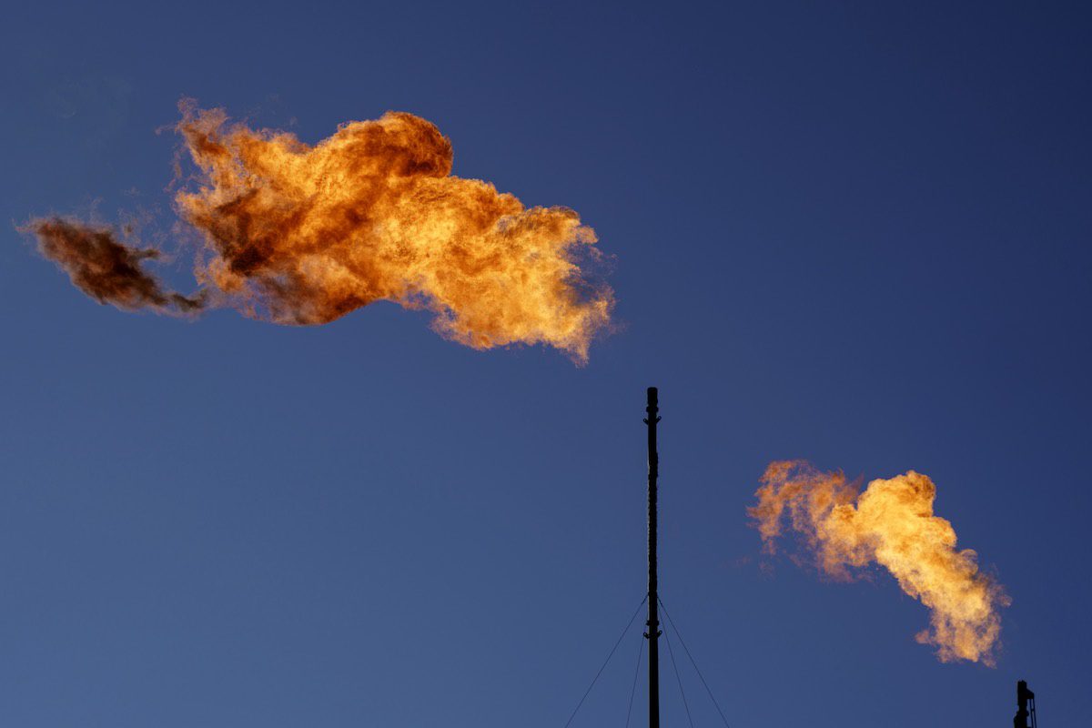 Flares burn off methane and other hydrocarbons at an oil and gas facility in Texas