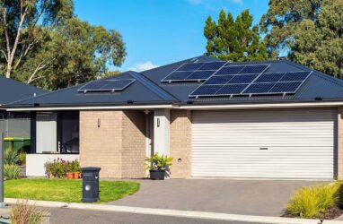 Rooftop solar suburbia plain small iStock-1291540475