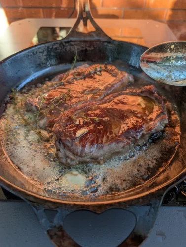Cooking butter basted steak outside. Source: Tim Eden