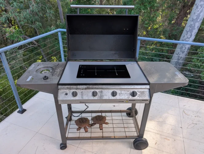 Induction cooktop installed into my old BBQ frame. Source: Tim Eden